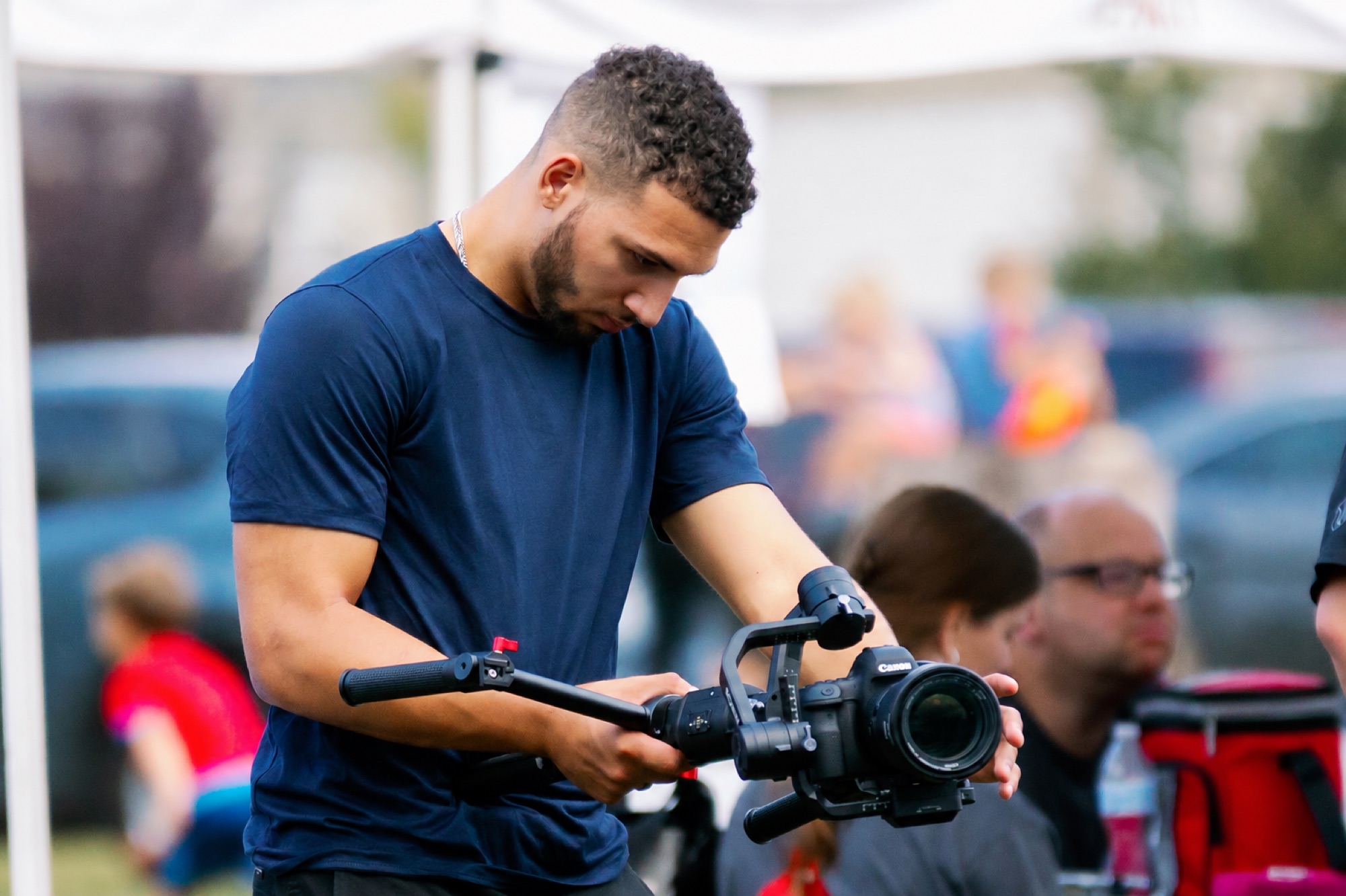 Marcus covering a community event with a gimbal rig