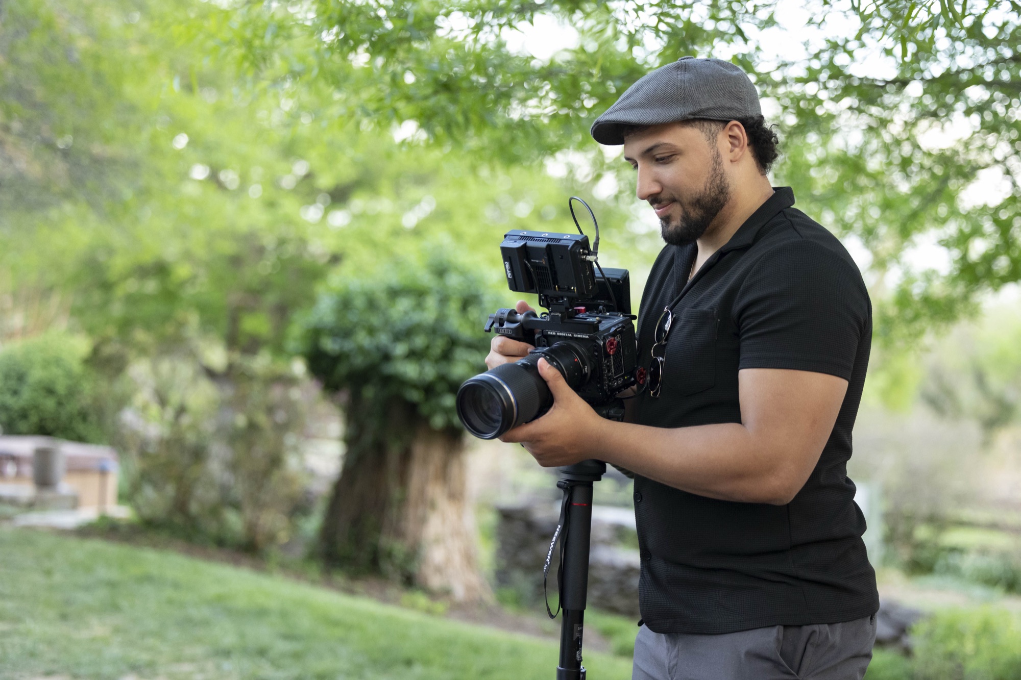 Marcus lining up a shot on a RED cinema camera outdoors