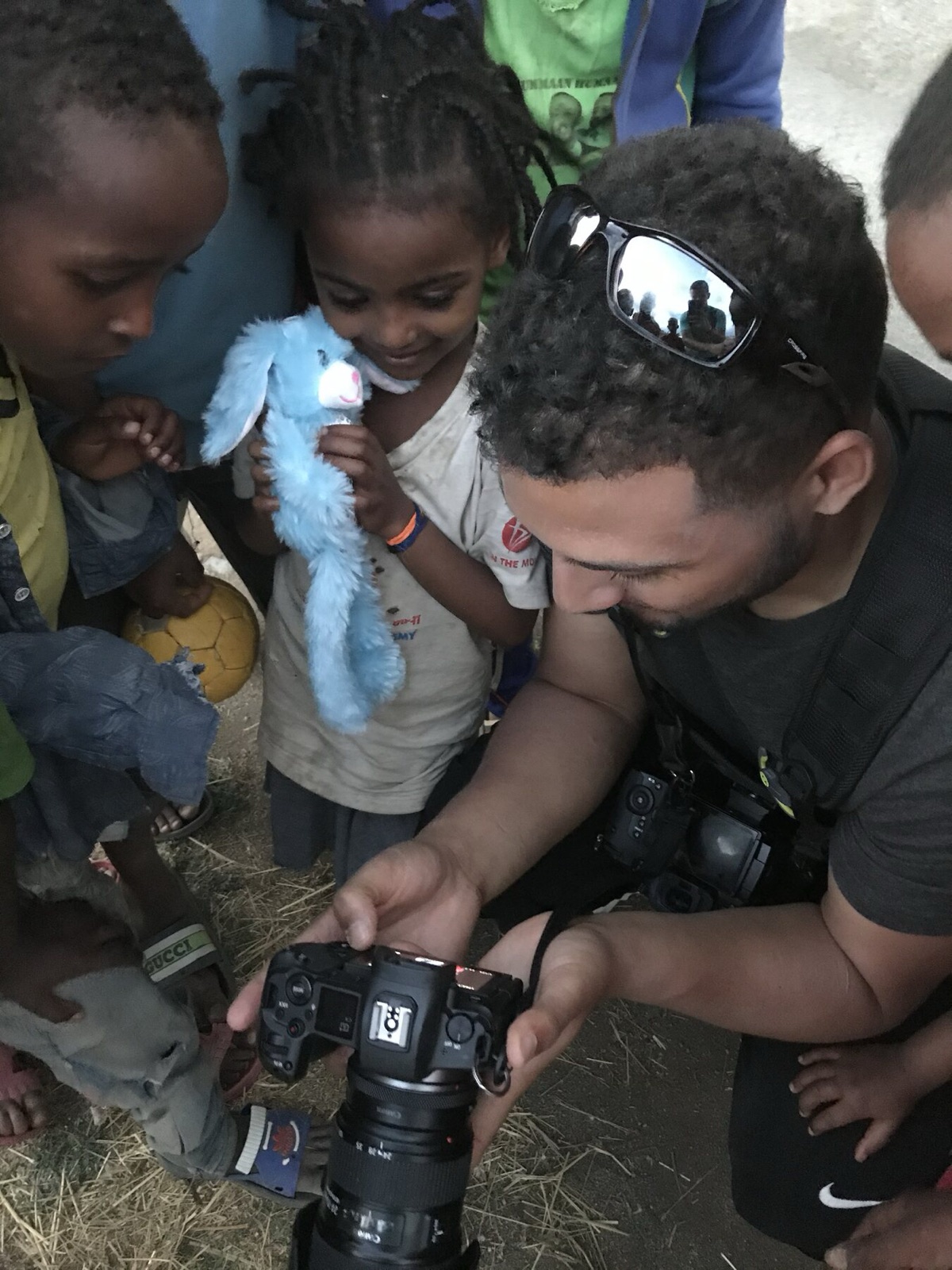 Marcus showing kids their photos on the back of his camera